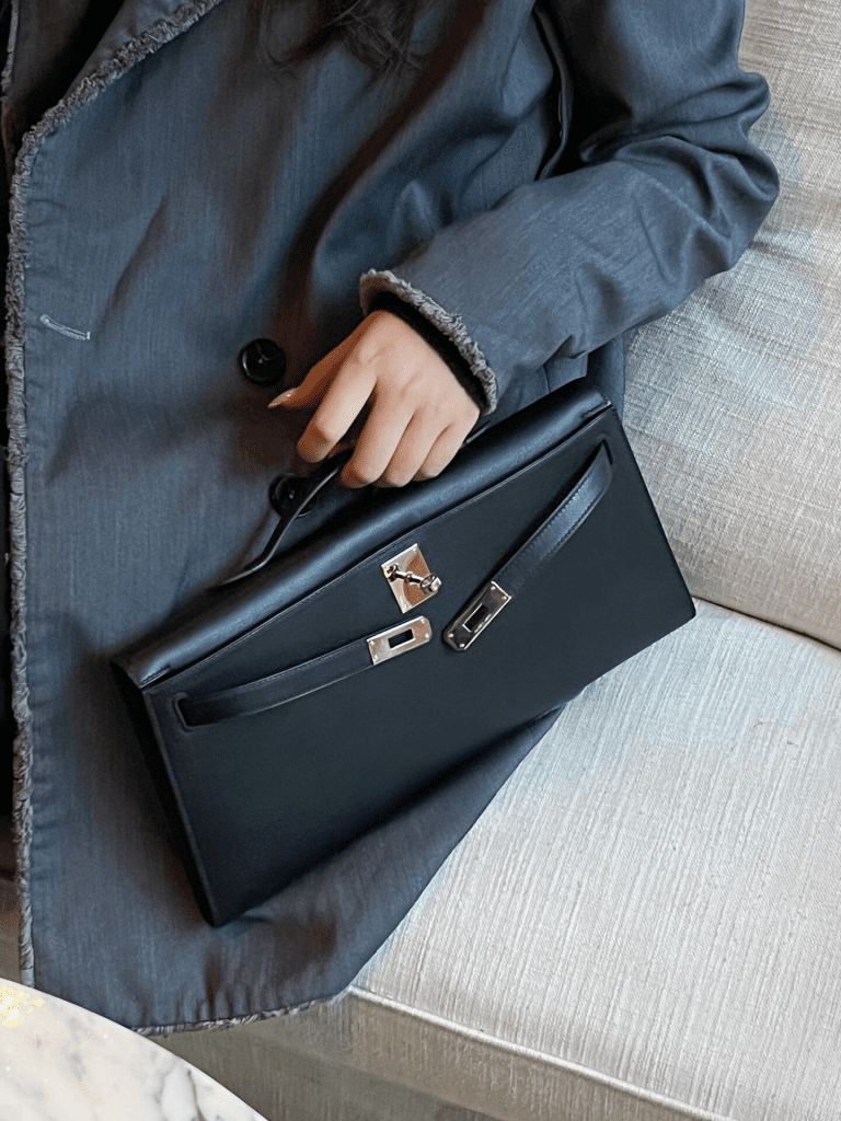 Kelly Cut Hermès clutch in black leather, sophisticated evening bag.