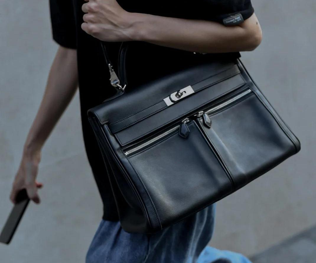 Close-up of Hermès Lakis black crossbody bag