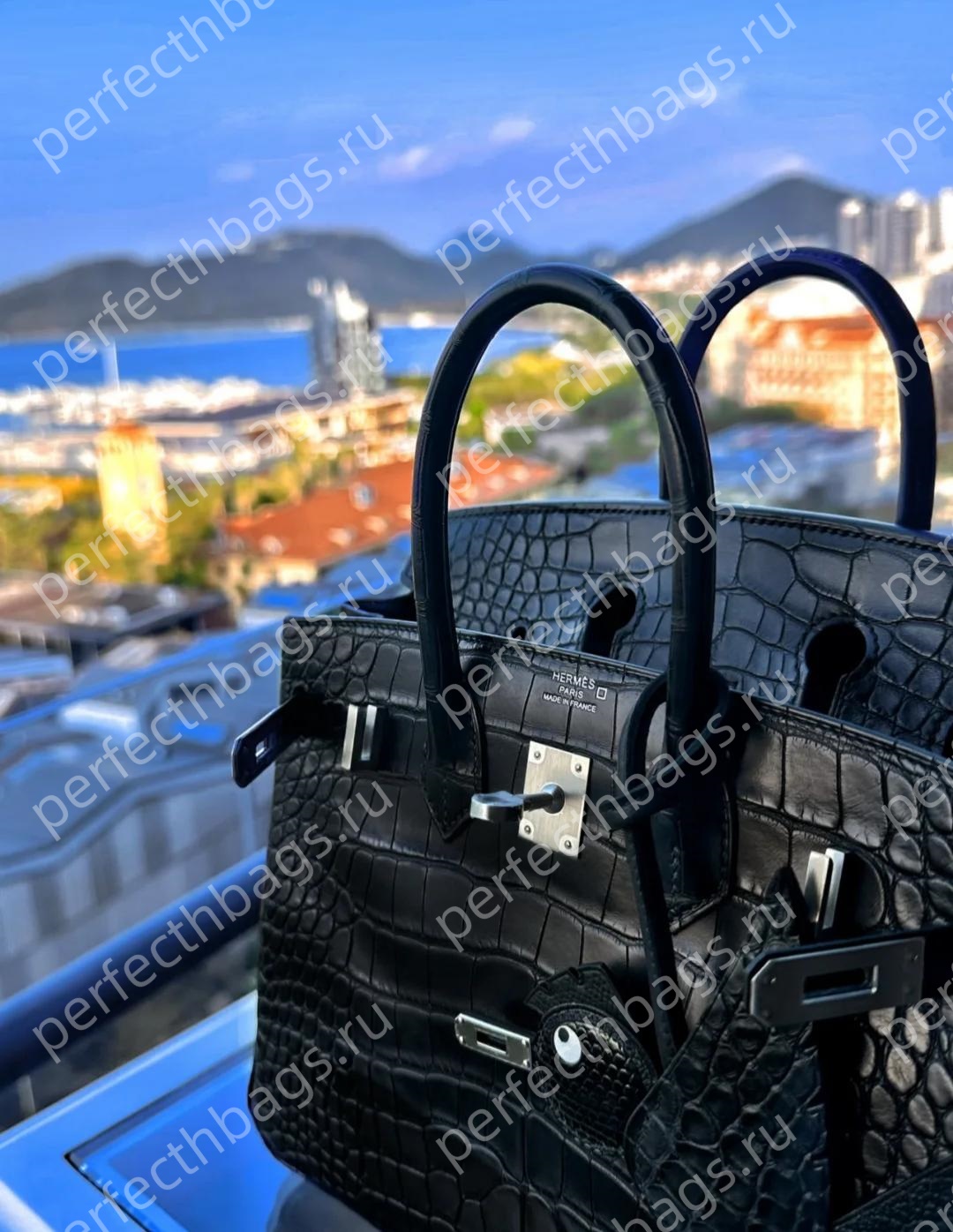 Close-up of a black crocodile Birkin bag with silver hardware