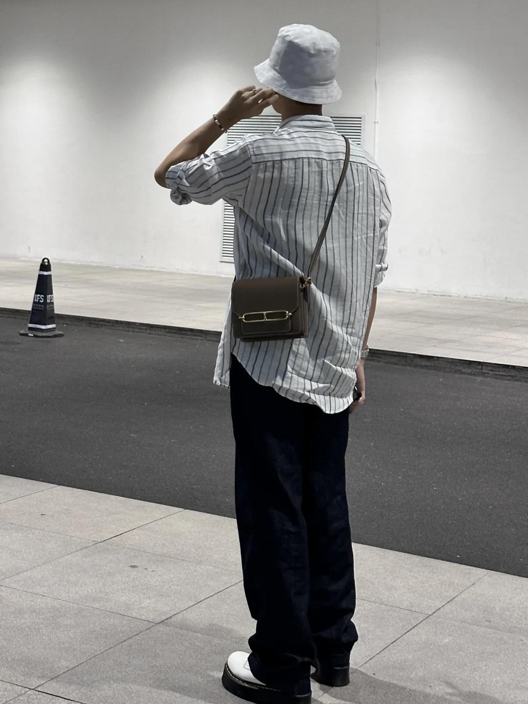 A person styling a Hermès Roulis 18