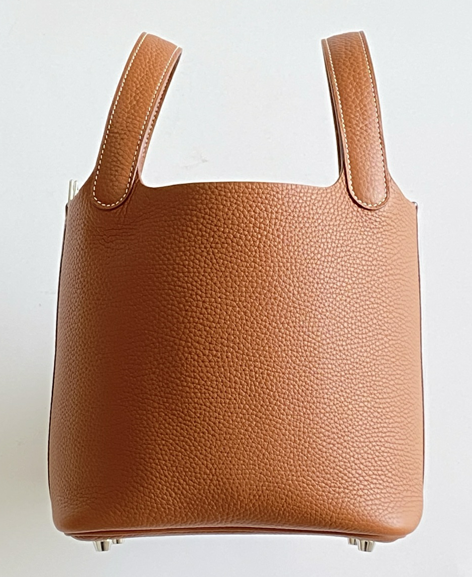A high-resolution product photograph of an Hermes Picotin bag in Gold Clemence leather
