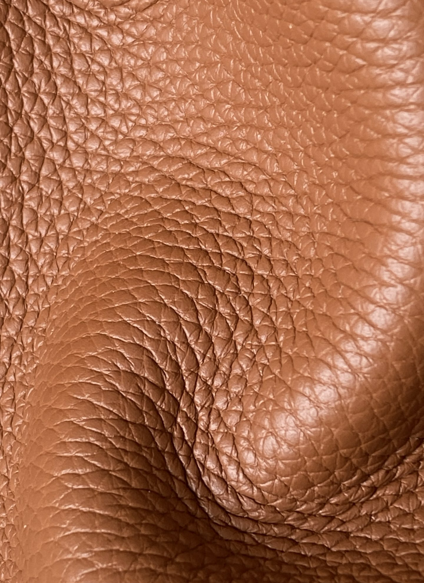 Macro texture close-up of Gold Clemence leather on the Hermes Picotin bag, revealing the full, open grain and high oil content.
