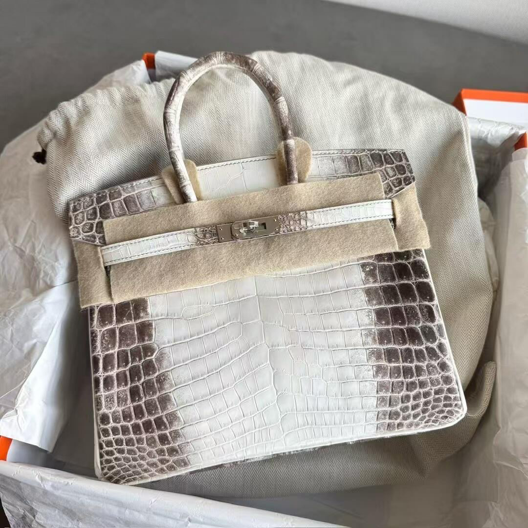 Close up of a Himalayan Birkin bag in its orange box with felt protector.