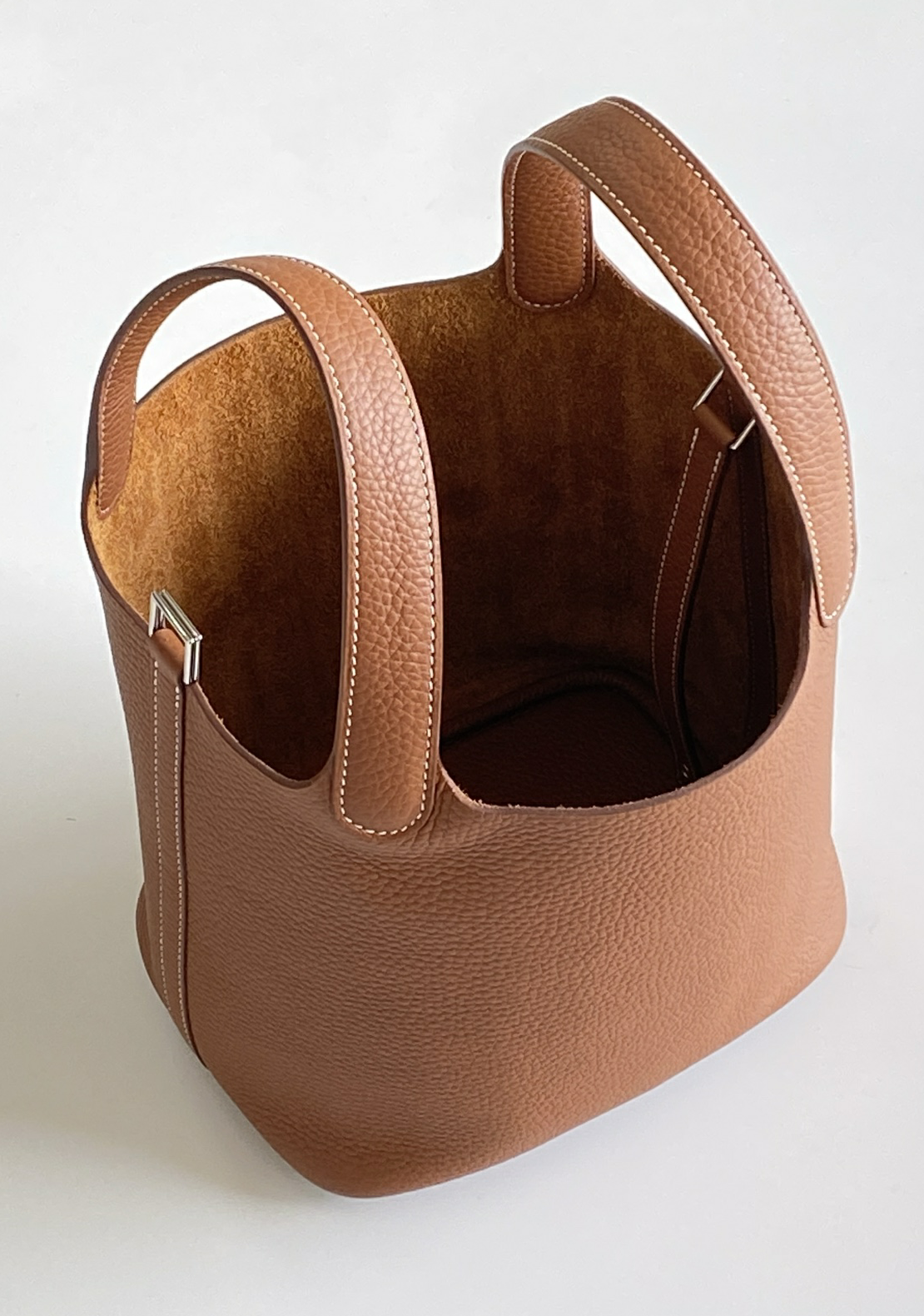 Overhead top-down view of the Gold Picotin 18 Hermes bag, showcasing the unlined interior and ample storage capacity.