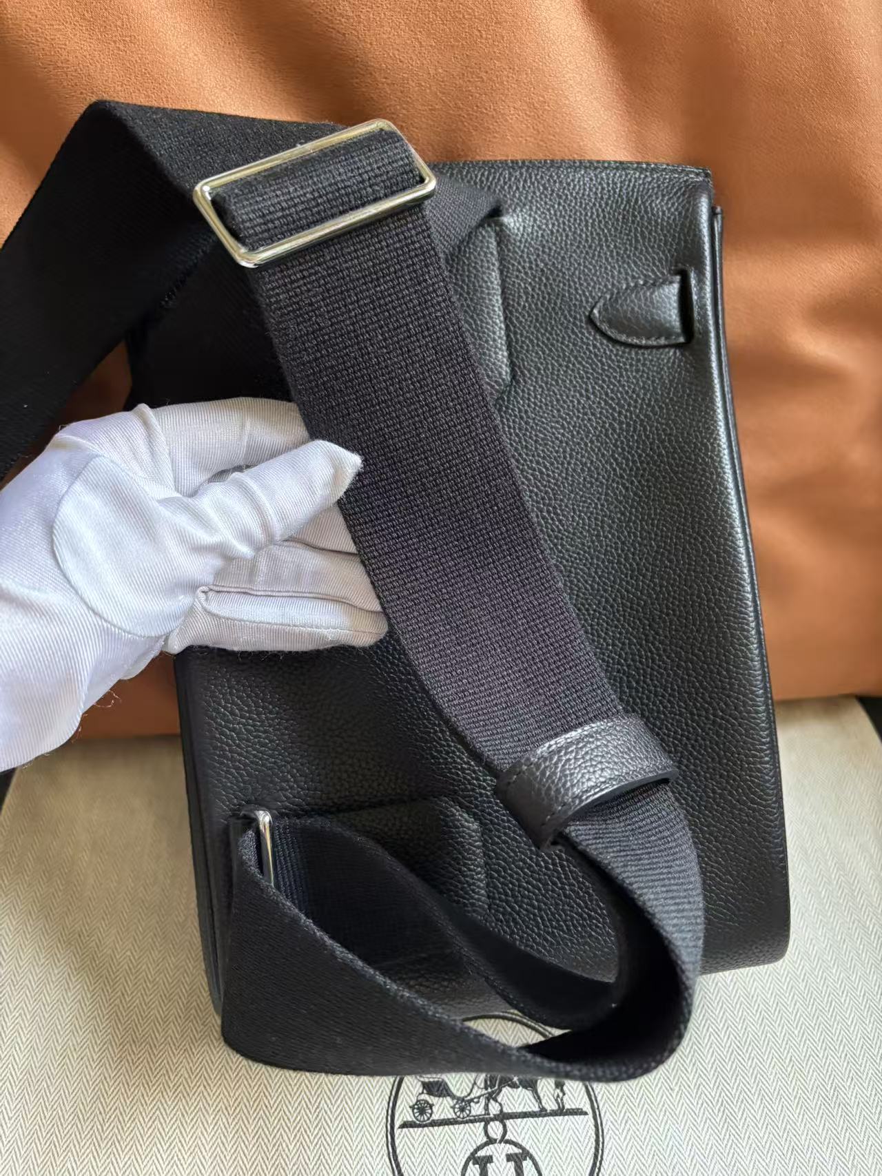 The back of the HAC a Dos PM highlighting the reinforced stitching where the canvas strap meets the Barenia Faubourg leather body.