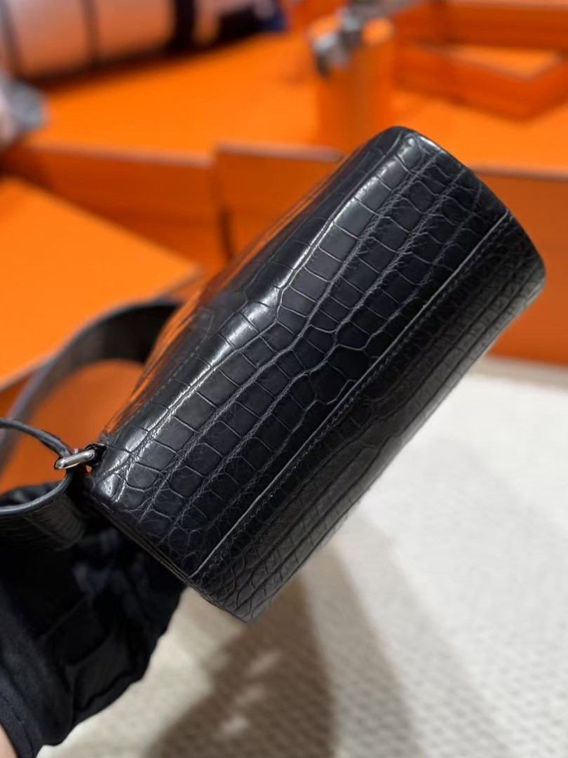 A close-up shot of the HAC a Dos PM in Matte Black Niloticus Crocodile leather