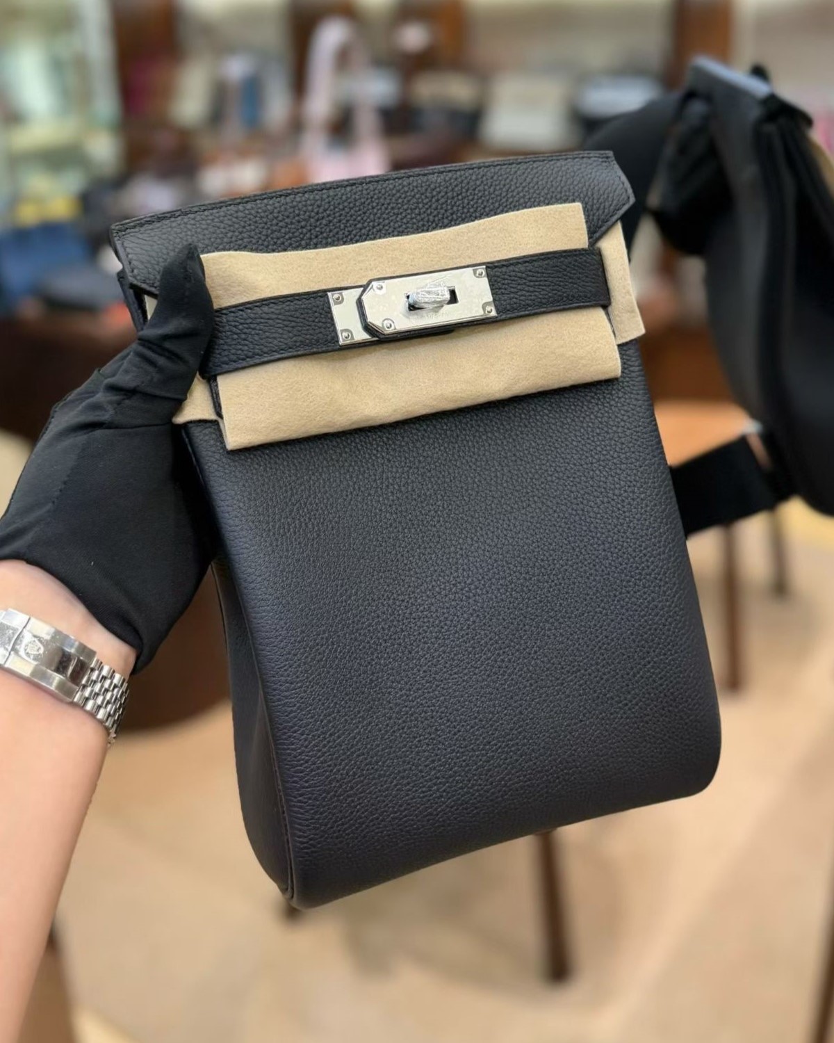 Front view of the HAC a Dos PM in Black Togo leather, featuring its iconic pebbled grain, white protective felt, and palladium hardware.